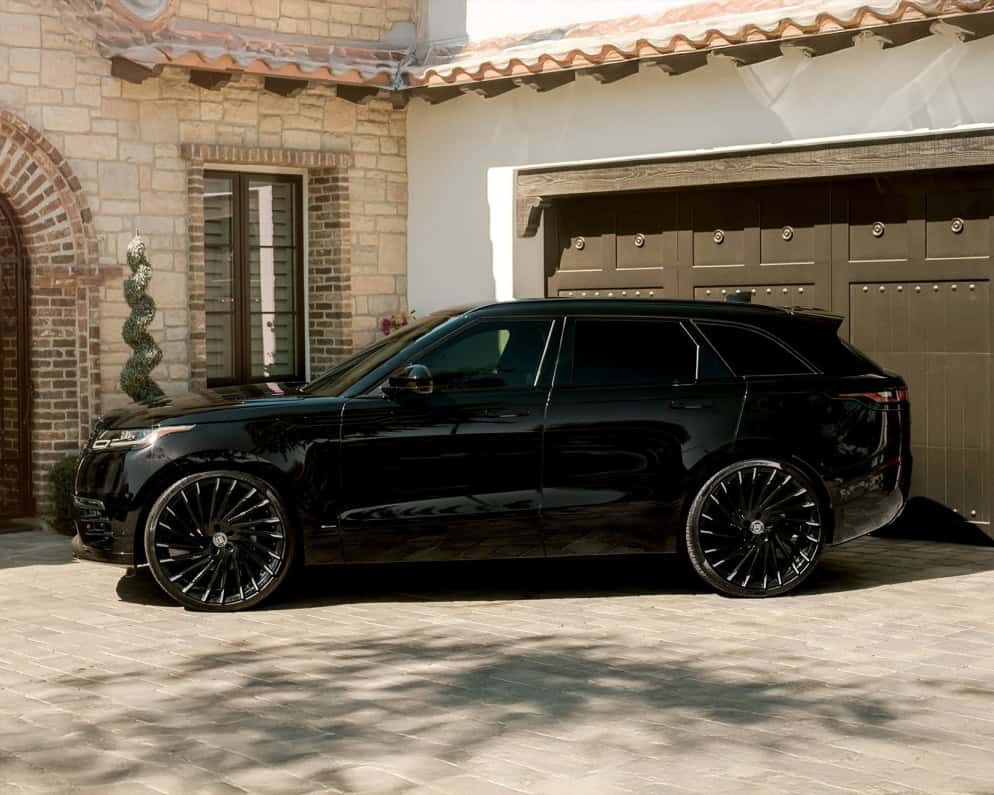Range Rover Wraith with custom Lexani wheels and sleek black finish.