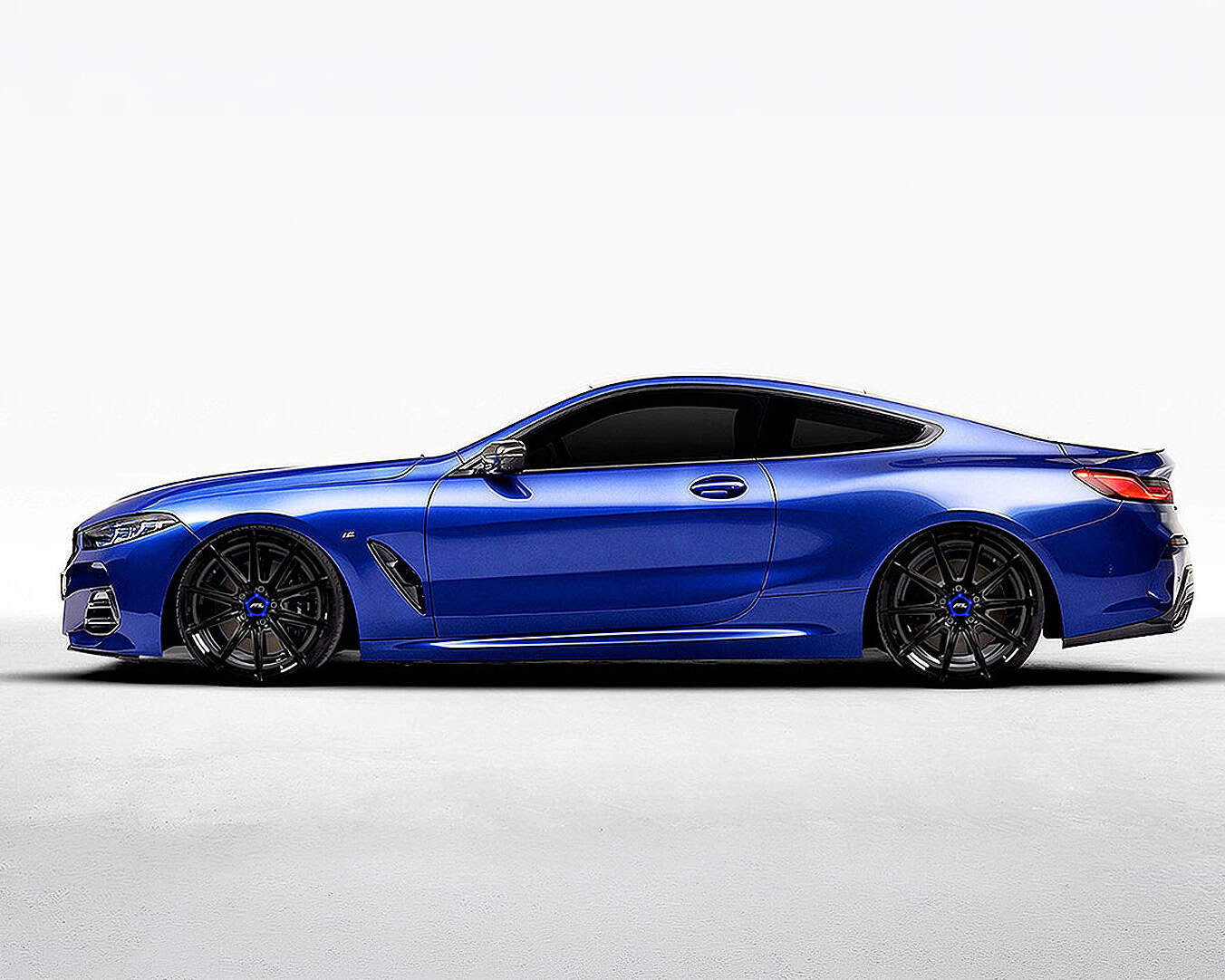 Blue luxury sedan with custom black alloy wheels and sleek design.