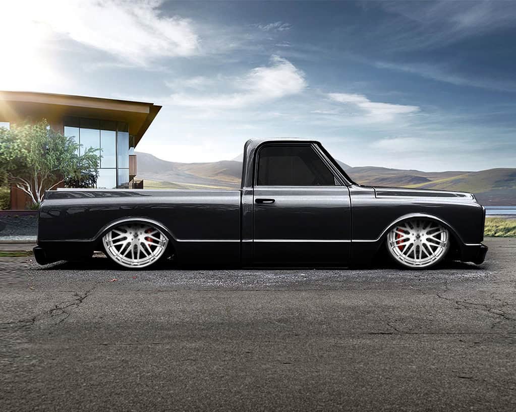 Custom black luxury truck with lowered suspension and stylish wheels.